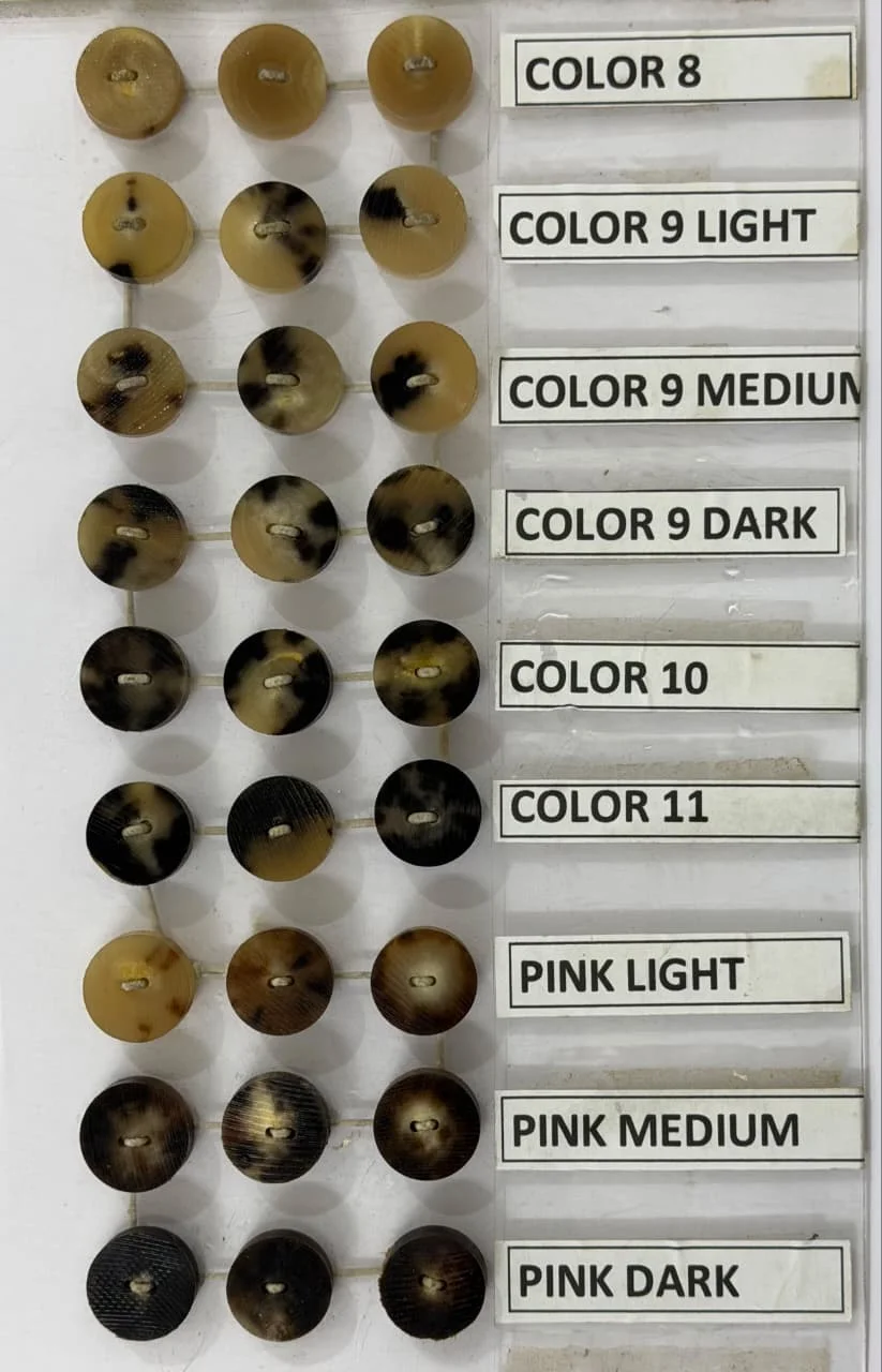 Horn button colour card showing nine natural shades